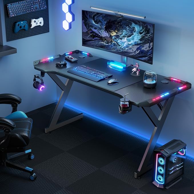HLDIRECT 63 INCH Gaming Desk with LED Lights, Home Office Gamer Desk, Ergonomic Computer Table with Large Carbon Fiber Desktop, Office Workstation with Mouse Pad, Cup Holder & Headphone Hook, Black