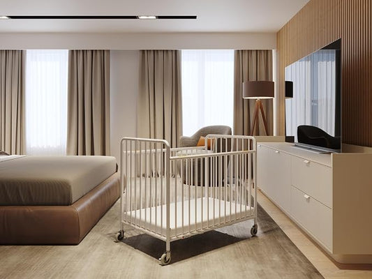 Foundations Stowaway Metal Baby & Toddler Folding Crib, Portable Baby Crib with Foam Mattress and Commercial Grade 3" Casters, Compact for Hotels, White