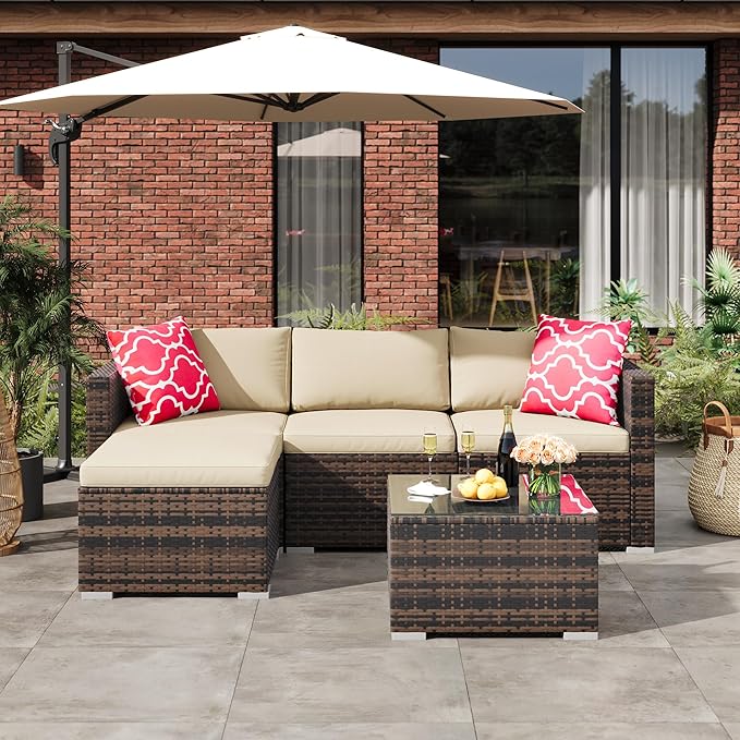 Outdoor patio set with sectional sofa, coffee table, and umbrella on a patio.