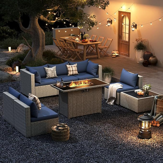 Outdoor patio setting with wicker furniture, fire pit, and string lights.