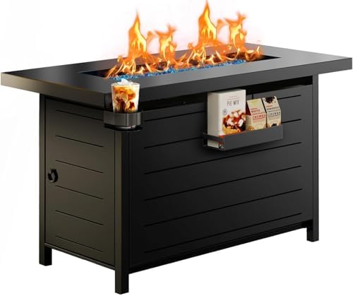 Black outdoor fire pit table with a built-in flame burner, side cup holder with an iced coffee, and a magazine rack holding cookbooks, shown on a white background.