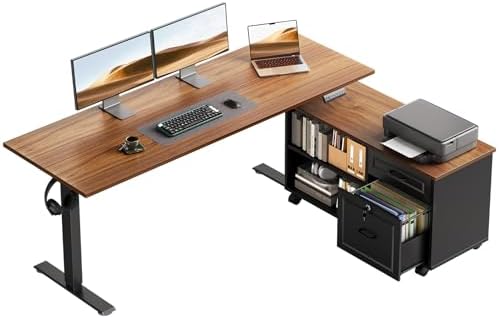 An L-shaped standing desk with a wood-grain desktop and black metal frame, shown with dual monitors, a laptop, keyboard, printer, books, and a storage drawer on a white background.