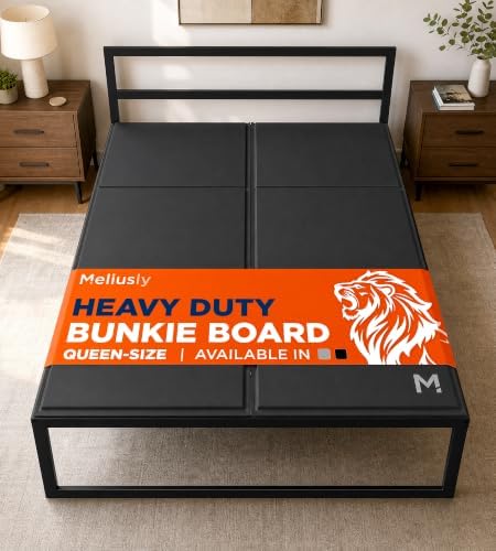 A black metal bunkie bed frame with a fold-out mattress shown in a bedroom setting, featuring a bright orange promotional banner across the center that reads 'Meliusy HEAVY DUTY Bunkie BOARD QUEEN-SIZE | AVAILABLE IN' with a lion graphic.