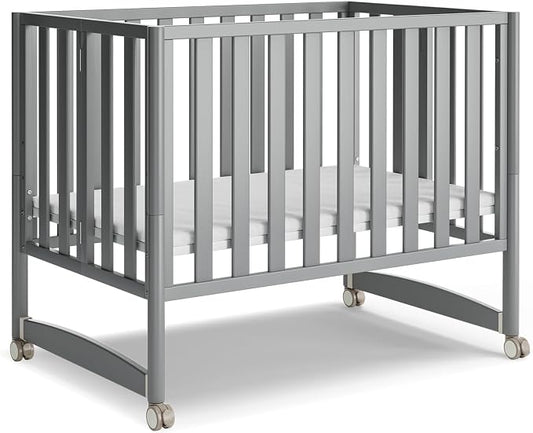 MAMAZING EvoNest 7-in-1 Convertible Baby Mini Crib with Wheels | GREENGUARD Gold Certified, New Zealand Pine Wood, 4 Adjustable Heights, Rocking Mode, Small Spaces Design, Grey
