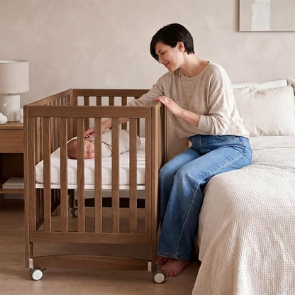 MAMAZING EvoNest 6-in-1 Convertible Baby Mini Crib with Wheels, GREENGUARD Gold Certified, 4 Adjustable Mattress Heights, 100% New Zealand Pine Wood, Portable Crib for Small Spaces, Walnut Brown