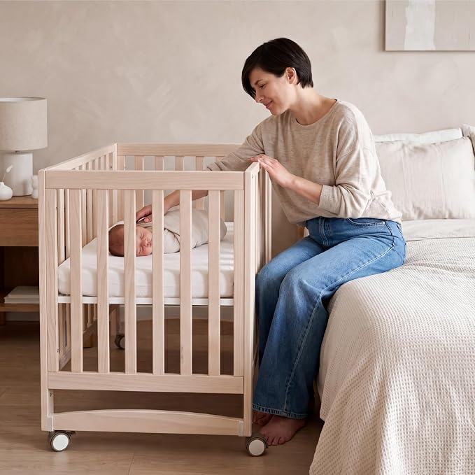 MAMAZING EvoNest 6-in-1 Convertible Baby Mini Crib with Wheels, GREENGUARD Gold Certified, 4 Adjustable Mattress Heights, 100% New Zealand Pine Wood, Portable Crib for Small Spaces, Washed Natural