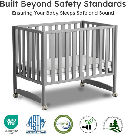 MAMAZING EvoNest 7-in-1 Convertible Baby Mini Crib with Wheels | GREENGUARD Gold Certified, New Zealand Pine Wood, 4 Adjustable Heights, Rocking Mode, Small Spaces Design, Grey