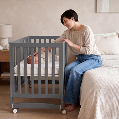 MAMAZING EvoNest 6-in-1 Convertible Baby Mini Crib with Wheels, GREENGUARD Gold Certified, 4 Adjustable Mattress Heights, 100% New Zealand Pine Wood, Portable Crib for Small Spaces, Gray