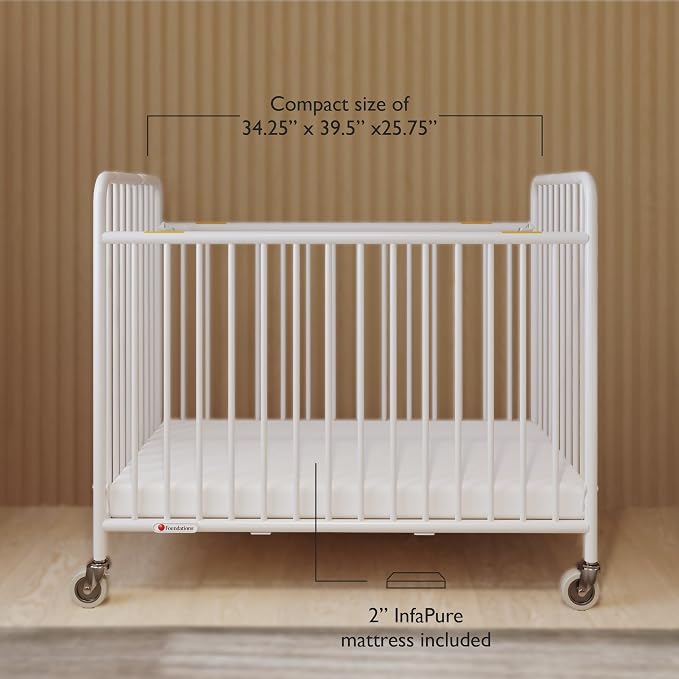 Foundations Stowaway Metal Baby & Toddler Folding Crib, Portable Baby Crib with Foam Mattress and Commercial Grade 3" Casters, Compact for Hotels, White