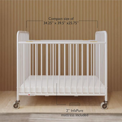 Foundations Stowaway Metal Baby & Toddler Folding Crib, Portable Baby Crib with Foam Mattress and Commercial Grade 3" Casters, Compact for Hotels, White