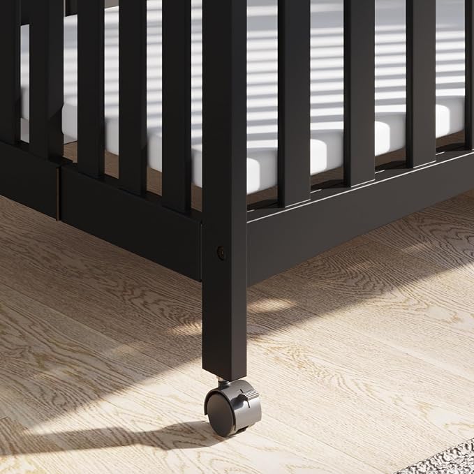 Child Craft London Mini Compact Folding Portable Crib with 2” Crib Mattress and 2 Easy Roll Locking Wheels, Durable Pine Wood Construction (Ebony Black)