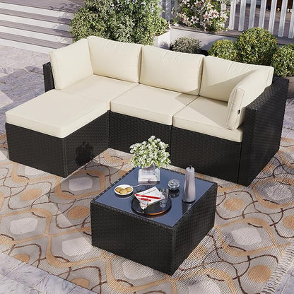 Outdoor patio set with sectional sofa and coffee table on a patterned rug.