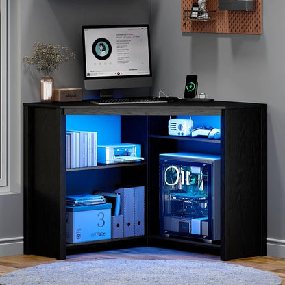 Corner Desk with Charging Station and LED Lights, Black | Triangle gaming computer desk for home office. Features space saving storage shelves, CPU stand, and smart LED light