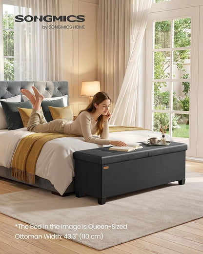 SONGMICS Storage Ottoman Bench with Legs, Folding Ottoman Foot Rest with Flipping Lid, Bench with Storage, for Living Room, Bedroom, Entryway, Synthetic Leather, 43.3 Inches, Ink Black ULSF085BH01