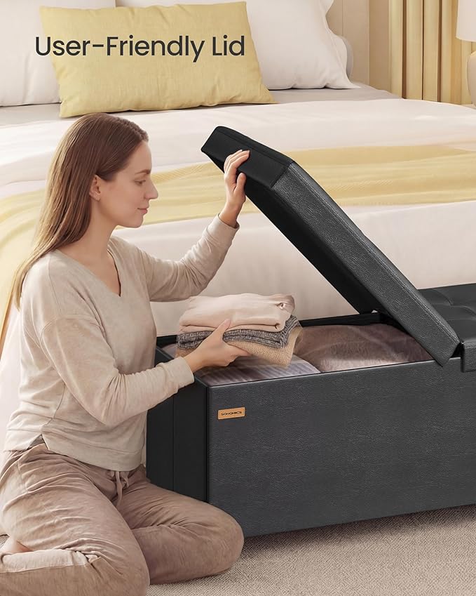 SONGMICS Storage Ottoman Bench with Legs, Folding Ottoman Foot Rest with Flipping Lid, Bench with Storage, for Living Room, Bedroom, Entryway, Synthetic Leather, 43.3 Inches, Ink Black ULSF085BH01