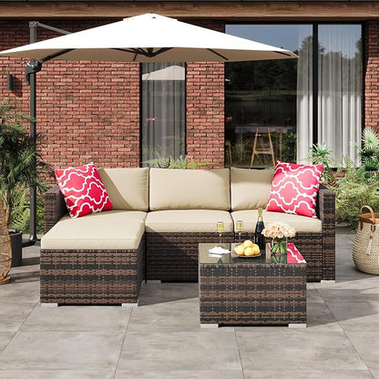 Outdoor patio set with sectional sofa, coffee table, and umbrella on a patio.