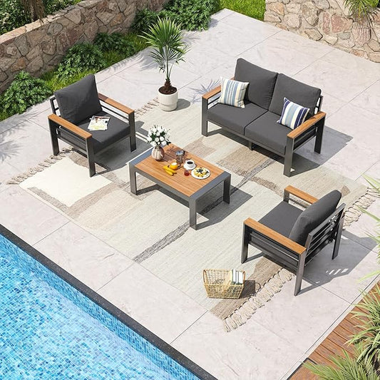 Outdoor patio set with gray cushions and wooden accents by a pool.