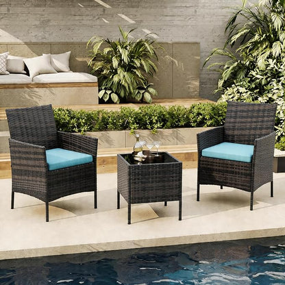 Outdoor patio set with two chairs and a table by a poolside.
