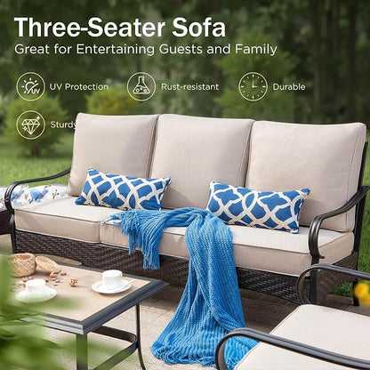 Three-seater outdoor patio sofa with beige cushions and a black wicker frame, styled with two blue-and-white patterned pillows and a blue throw blanket. The image includes marketing text and feature icons for UV protection, rust resistance, durability, and strength, set against a blurred green garden background.